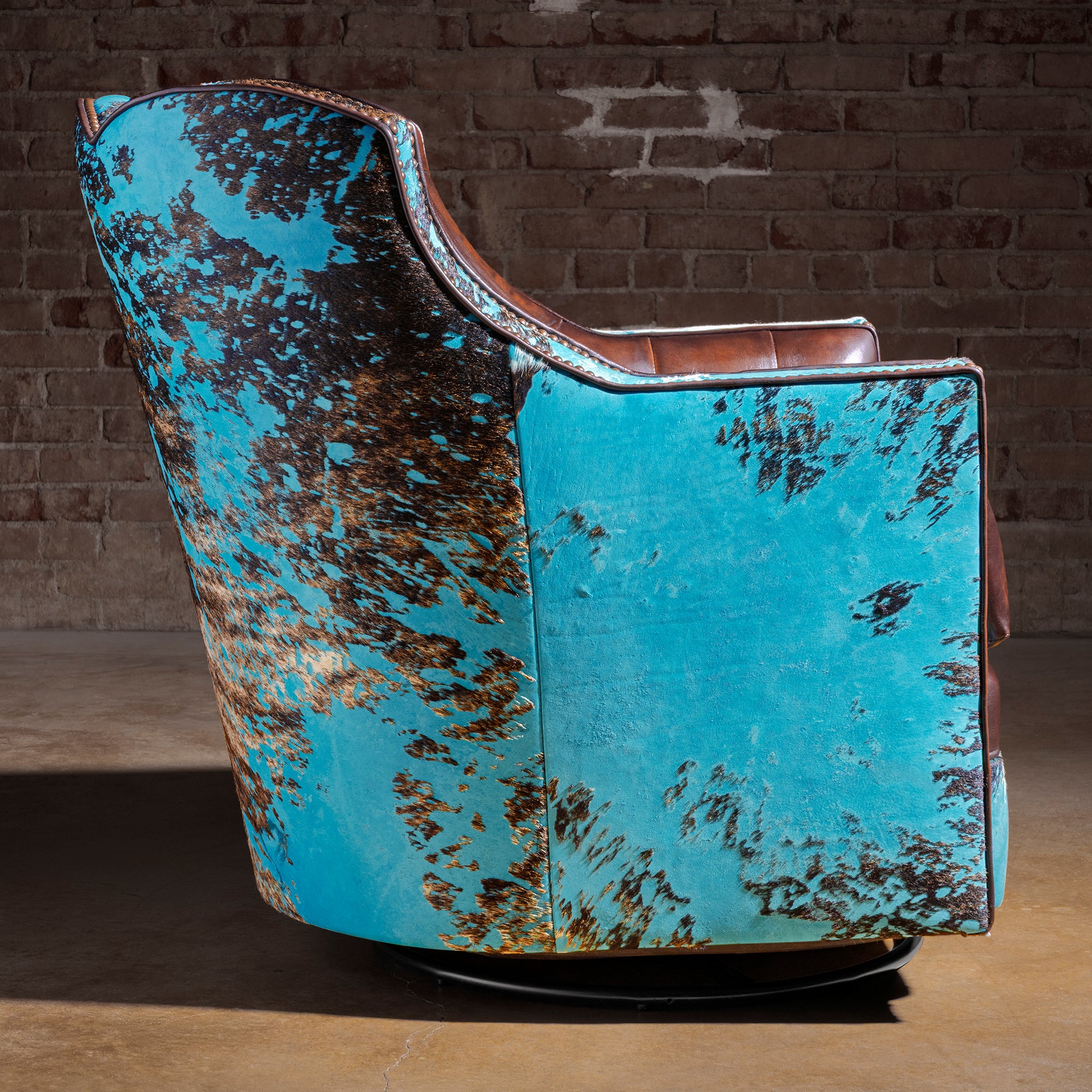 Azure Spur Tufted Western Swivel Chair western swivel chair side profile with turquoise cowhide shell and hidden swivel base.