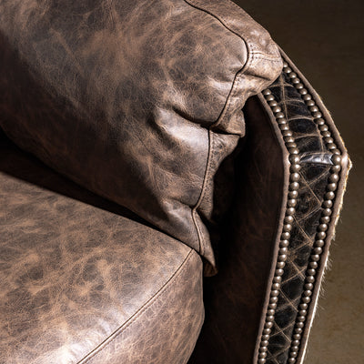 Nailhead and leather trim close-up on Bitterroot Hide Cuddler Recliner, upscale Western craftsmanship detail