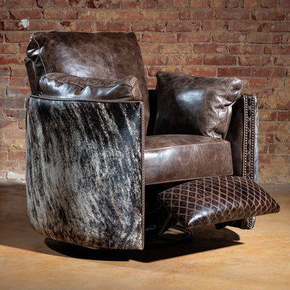 Western cowhide recliner chair in full recline with leather cushioning and swivel base