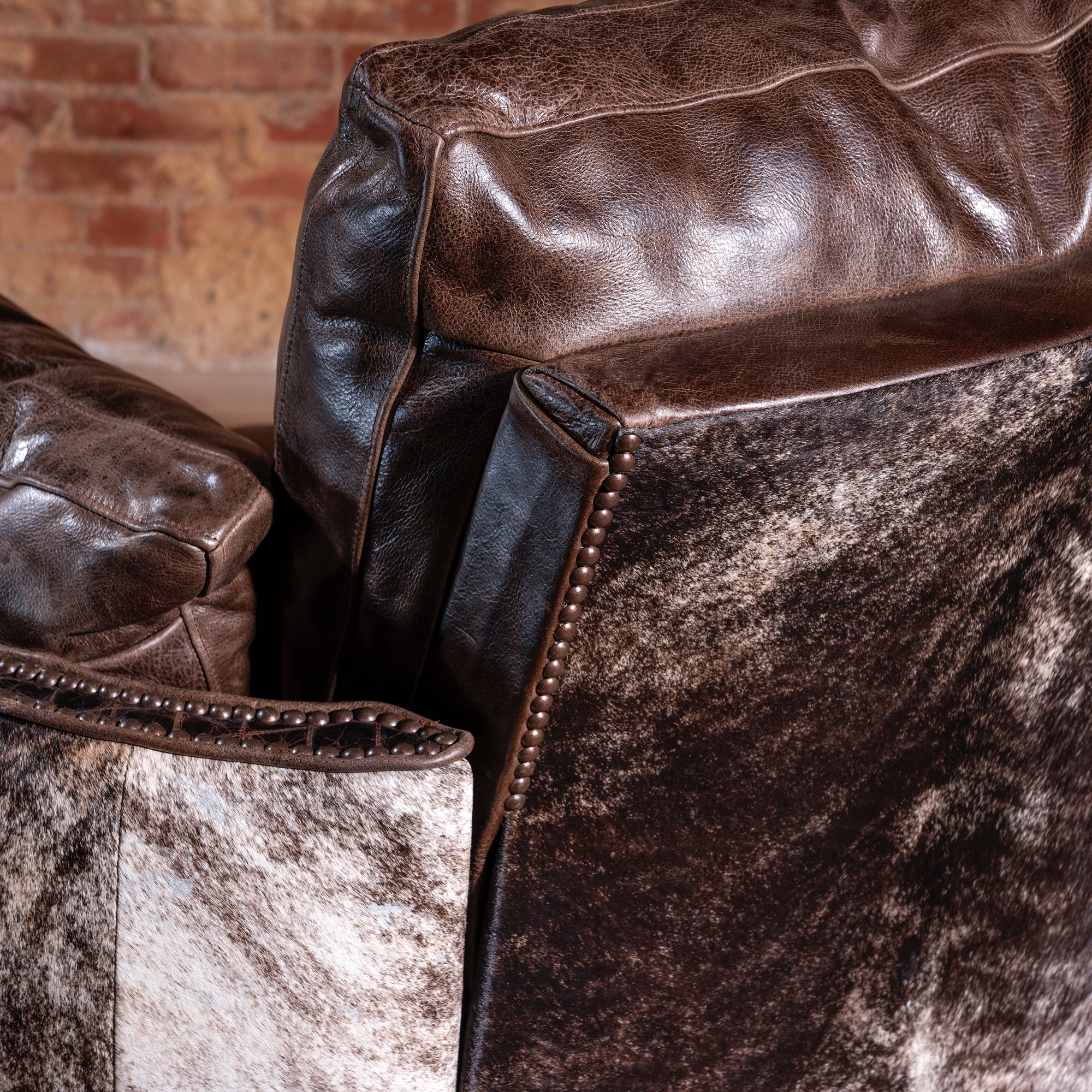 Brindle cowhide pattern on back of Western swivel recliner chair