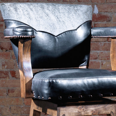 Close-up of leather and cowhide yoke detail on Western stool