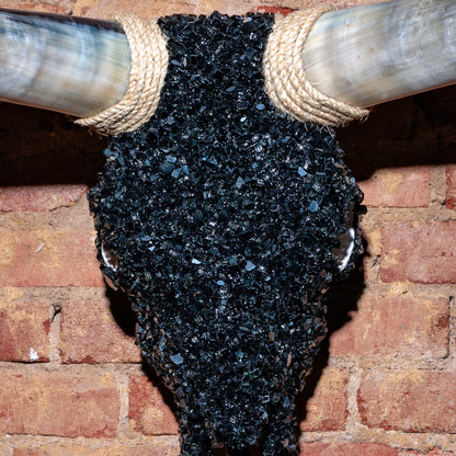 Close-up of crushed black glass texture and rope accent on bull skull wall mount