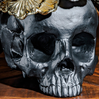 Close-up of matte black skull and gold flower details