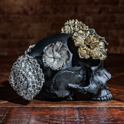 Side view of skull with silver and gold flowers