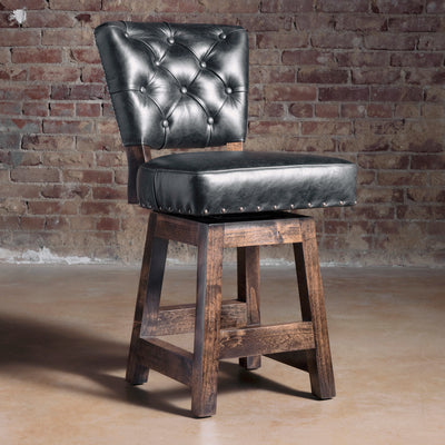 Black tufted leather Western bar stool with alder wood frame, dark stained legs, and nailhead trim—luxury ranch bar seating