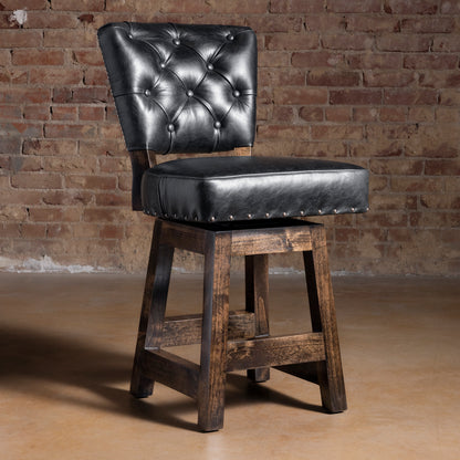Black tufted leather Western bar stool with alder wood frame, dark stained legs, and nailhead trim—luxury ranch bar seating