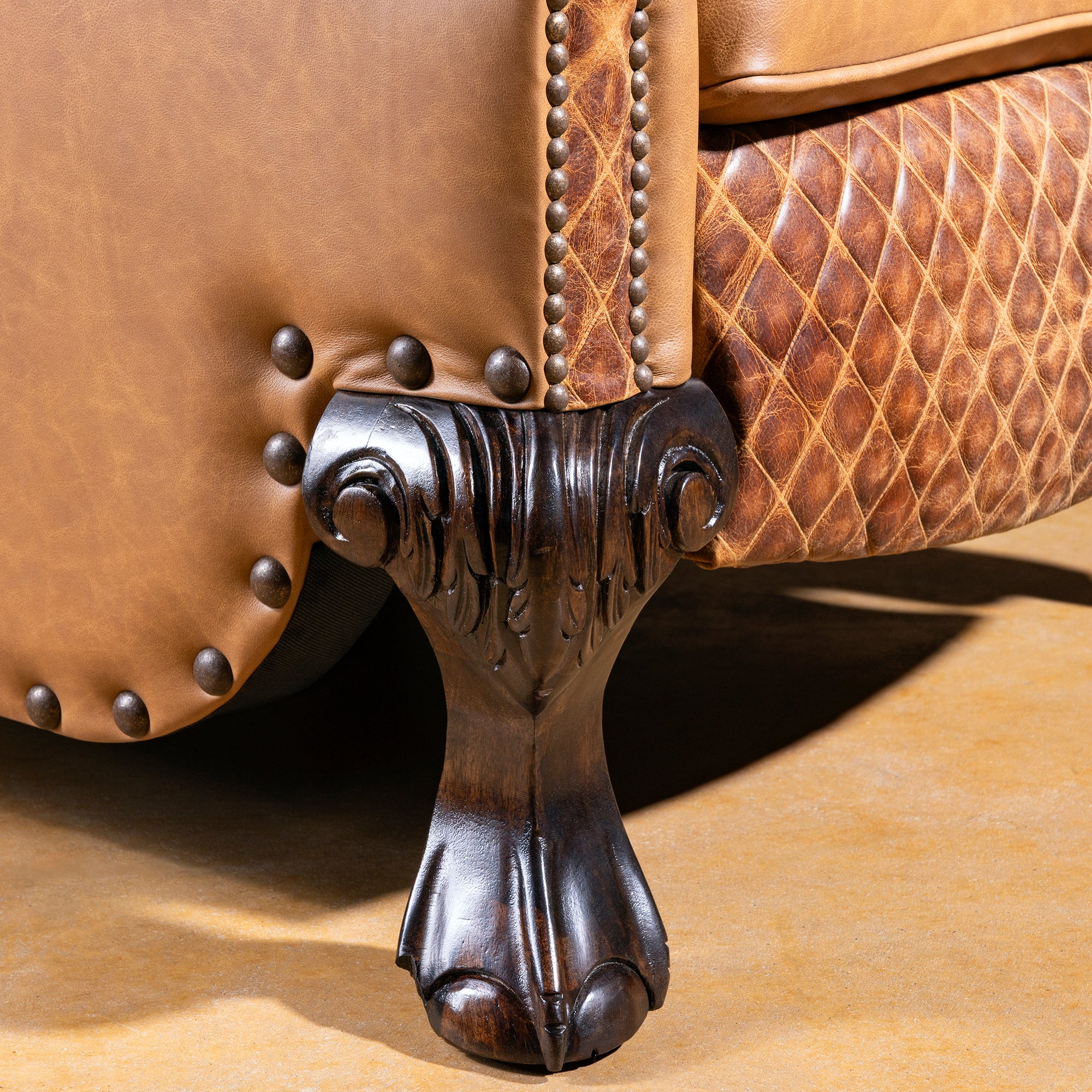 Hand-carved wooden foot detail with nailhead trim on the Bonanza Ranch Recliner