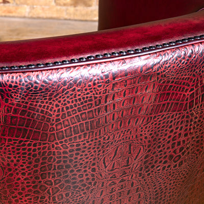 Bordeaux Croc Chair western swivel chair with deep red leather seat, curved arms, bronze nailheads, and swivel base