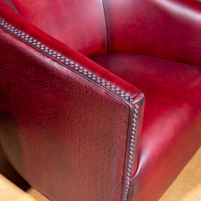 Bordeaux Croc Chair western swivel chair closeup with red leather seat, croc texture, and bronze nailhead trim