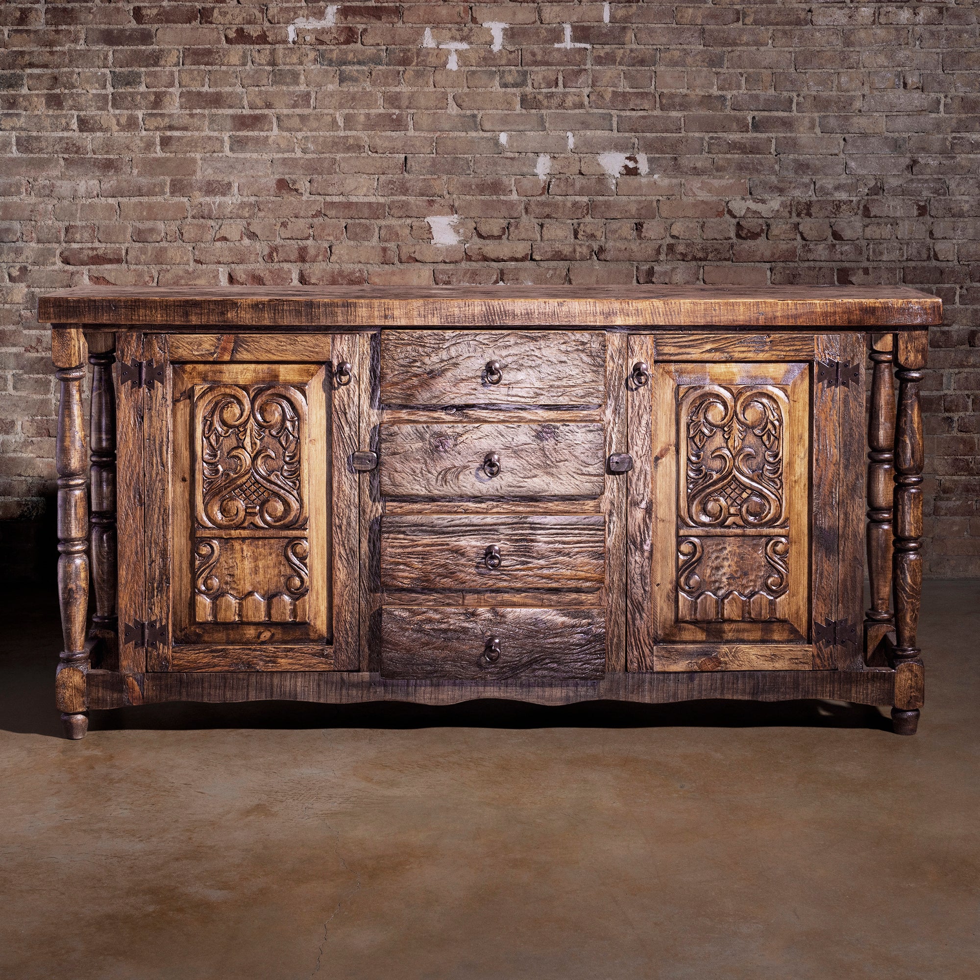 Front view of reclaimed wood Western buffet with carved panels and drawers