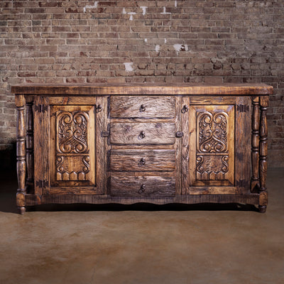 Front view of reclaimed wood Western buffet with carved panels and drawers