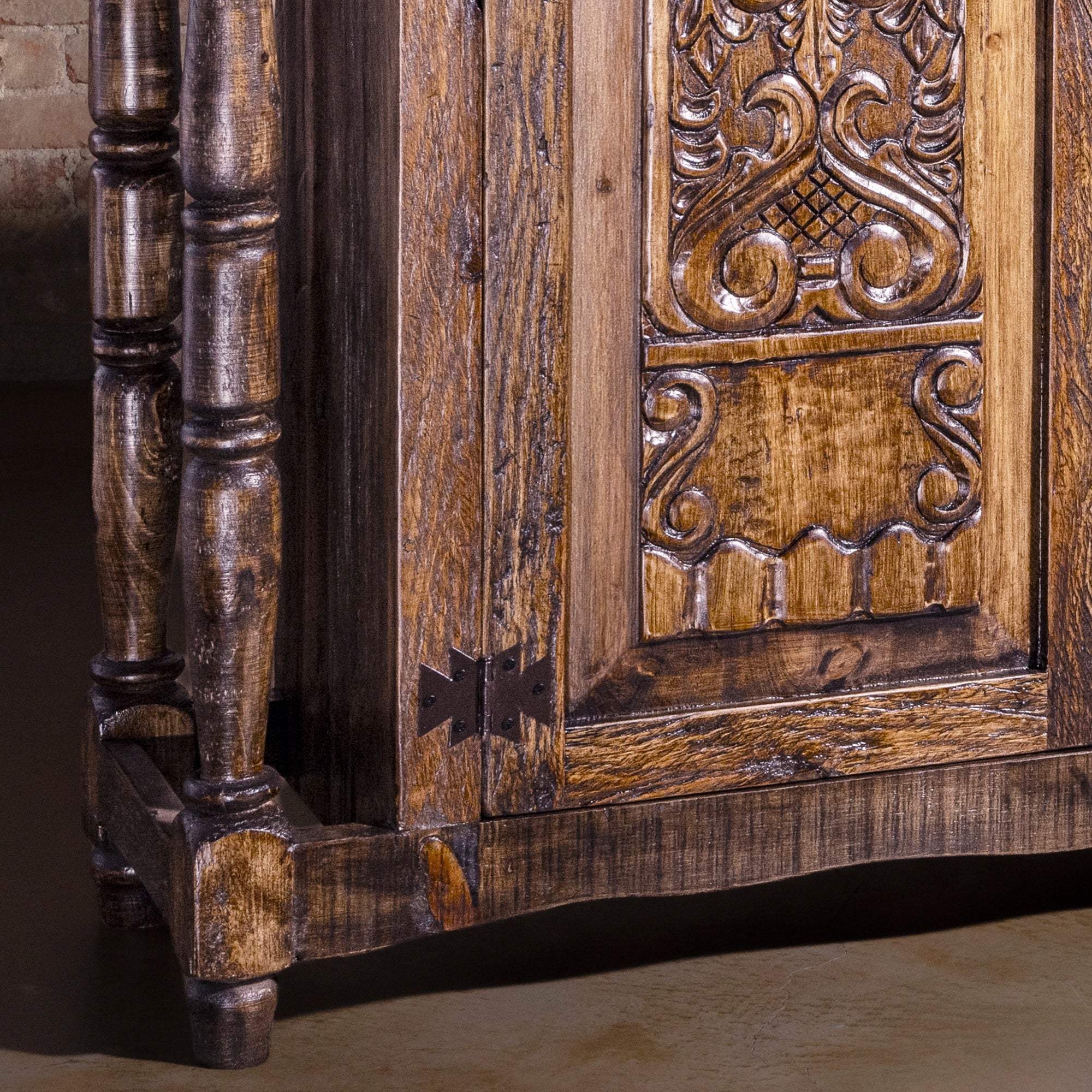 Detail of rustic turned leg base and aged wood finish on Western buffet