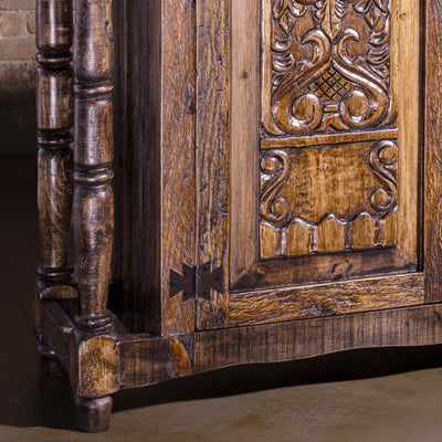 Detail of rustic turned leg base and aged wood finish on Western buffet