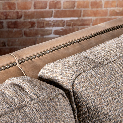 Bridger Nailhead Sofa western sofa with tan leather back, antique nailhead trim, and textured woven cushions