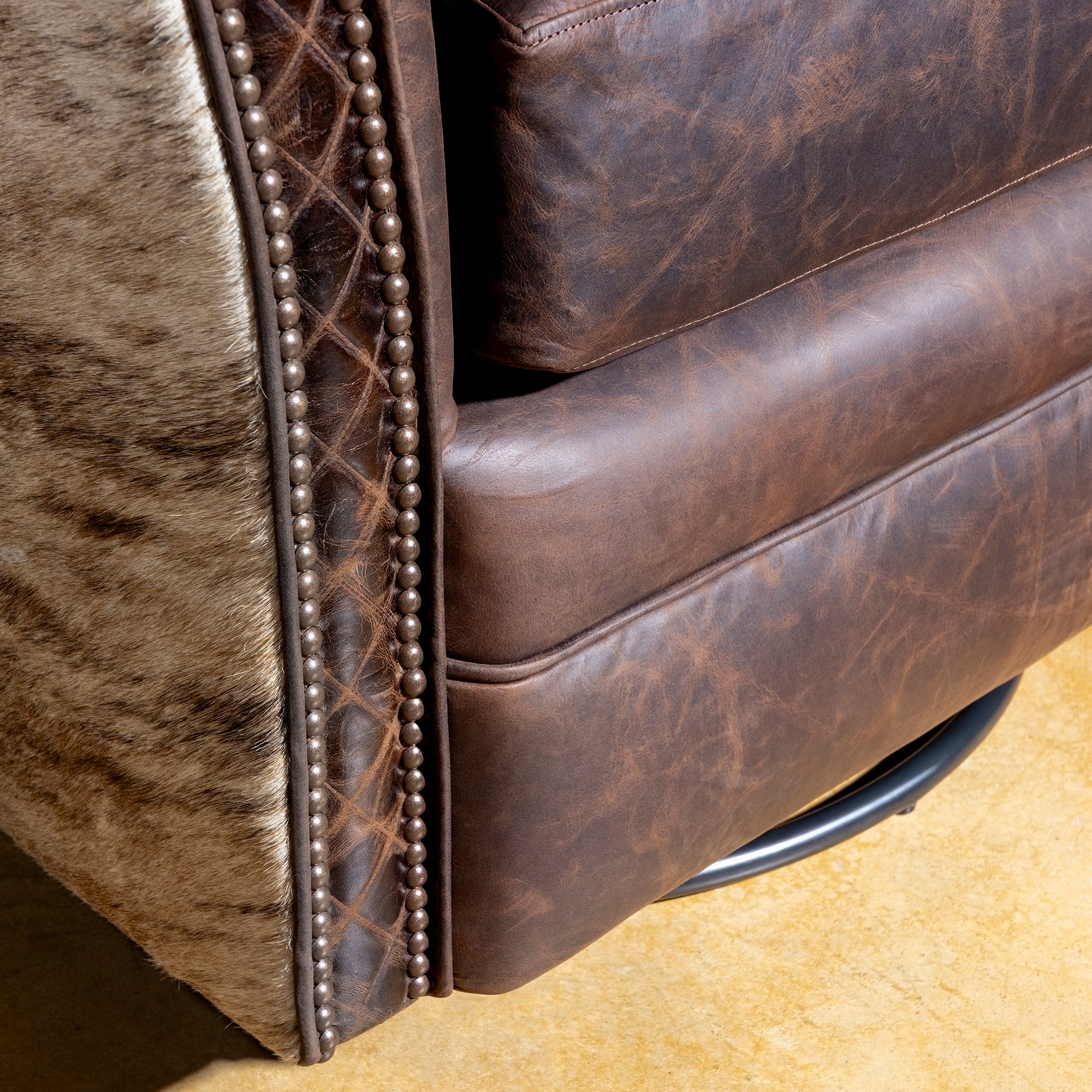 Brindle Cavalier Cowhide Western Swivel Chair with distressed top-grain leather, Brazilian cowhide panels, croc trim, and nailheads.