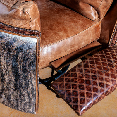 Close-up of brindle cowhide and top-grain leather on handcrafted Western chair