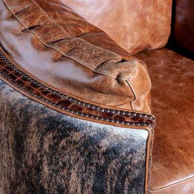 Close-up of brindle cowhide and top-grain leather on handcrafted Western chair