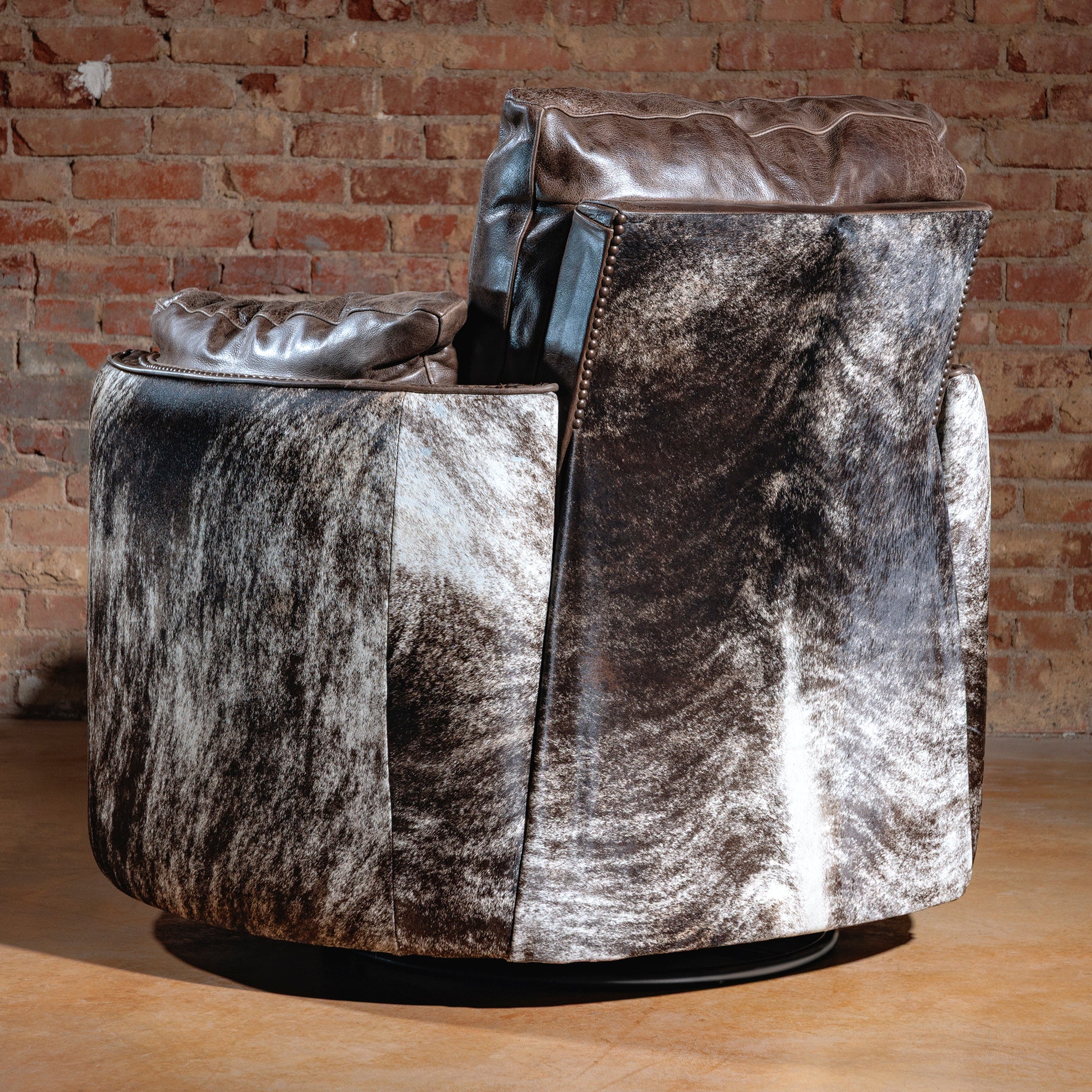 Brindle cowhide pattern on back of Western swivel recliner chair