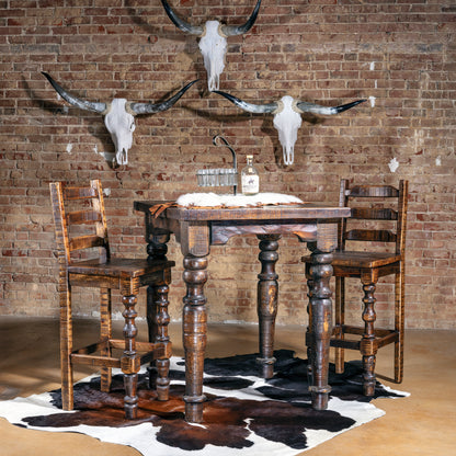 Western pub table and stools in bar scene with longhorn skull wall décor.