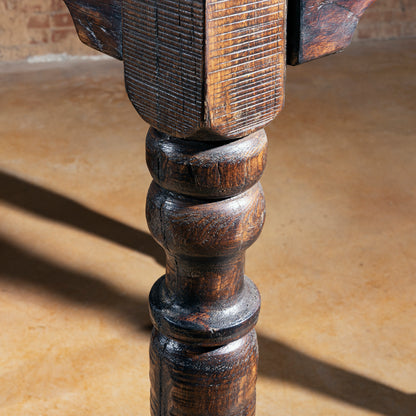 Detailed view of pub table leg with distressed Western finish.