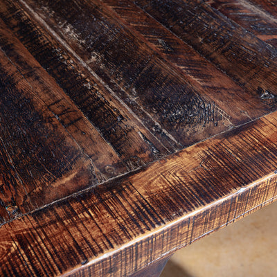 Reclaimed wood tabletop with rich texture and saw marks.