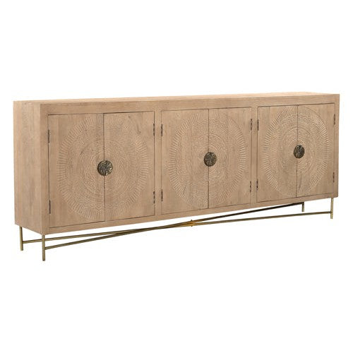 The Brooklyn 6 Door Natural Carved Sideboard combines hand carved doors and gold metal accents with a natural wood finish. With ample storage space, this sideboard is both elegant and functional, making it the perfect addition to any home.