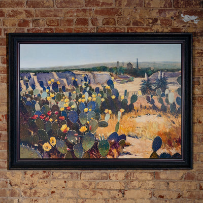 Framed Western landscape oil painting featuring desert canyon and blooming cactus