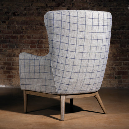 High-back western fireside chair in gray windowpane upholstery with wood base, modern ranch reading chair rear view