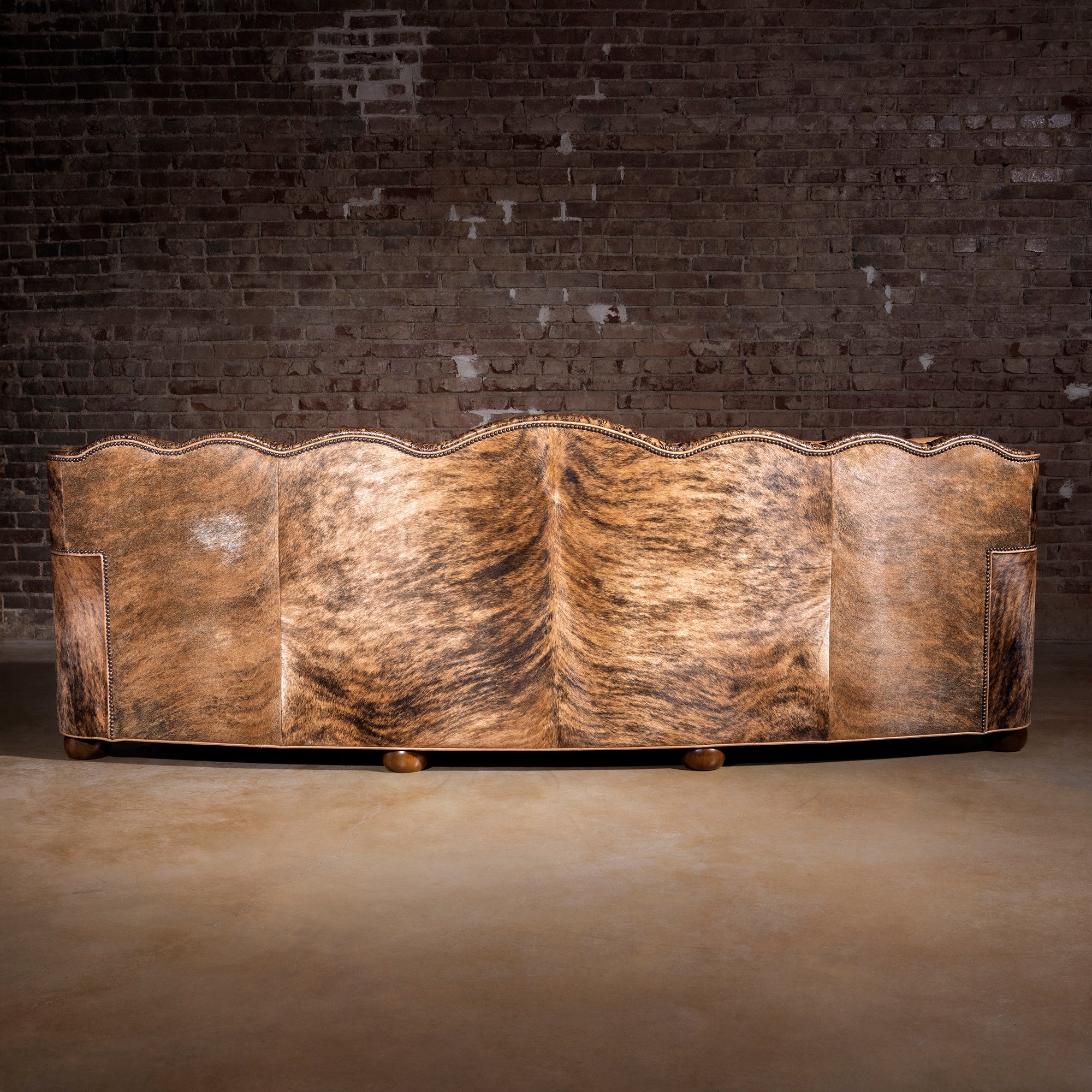 Full back view showing Brazilian brindle cowhide on Western leather statement sofa