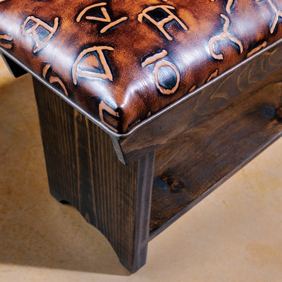 Close-up of branded leather upholstery with rustic Western detailing
