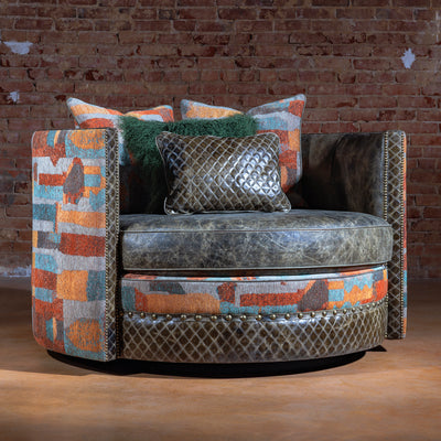 Luxury Western swivel chair with throw pillows and nailhead trim