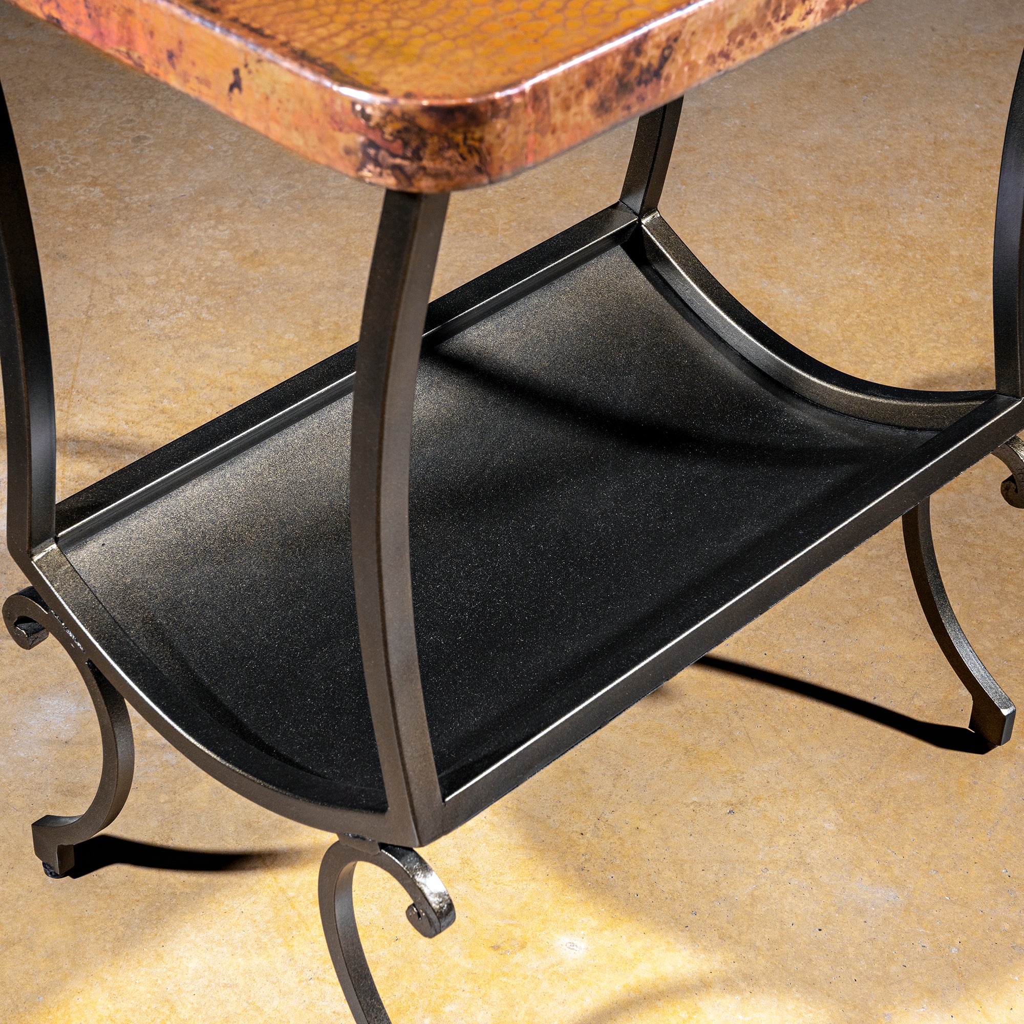 Cobre Scroll Table western accent table with hammered copper top, wrought iron frame, curved legs, and lower shelf