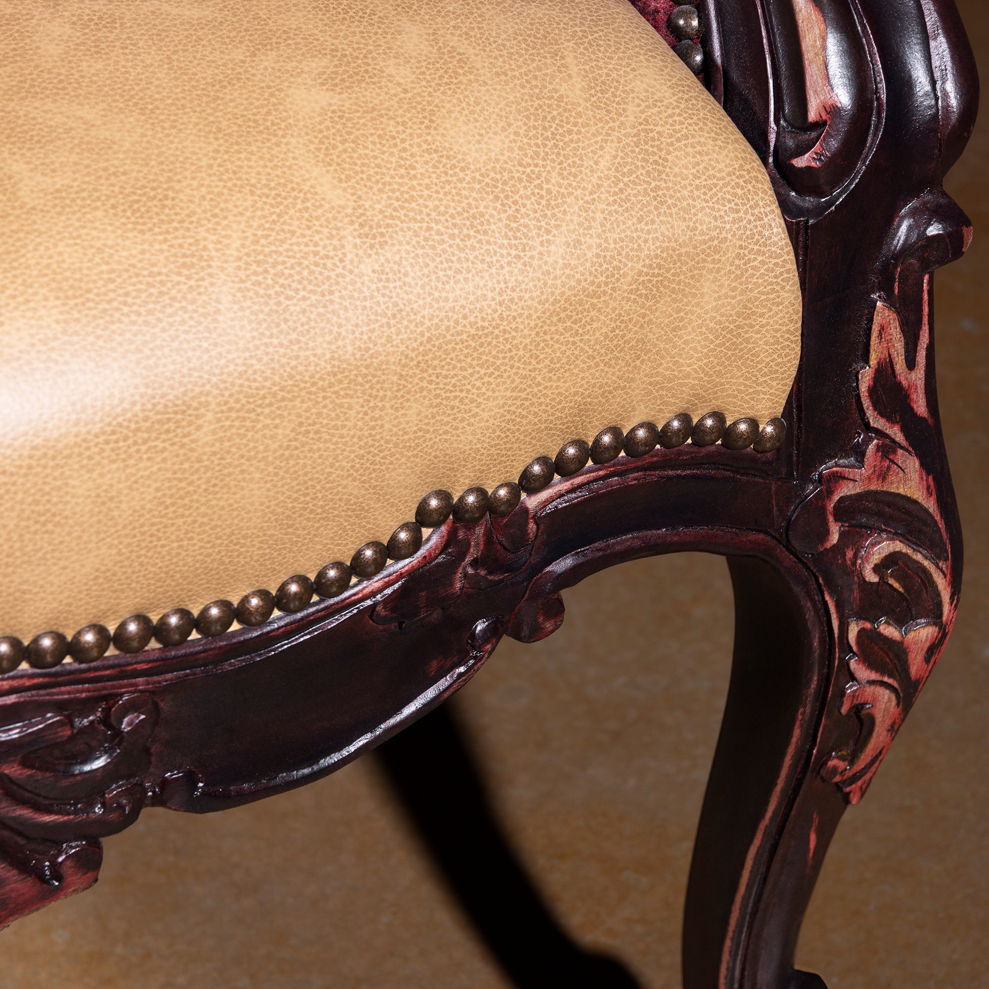 Leather seat close-up with nailhead trim on hand-carved Western chair
