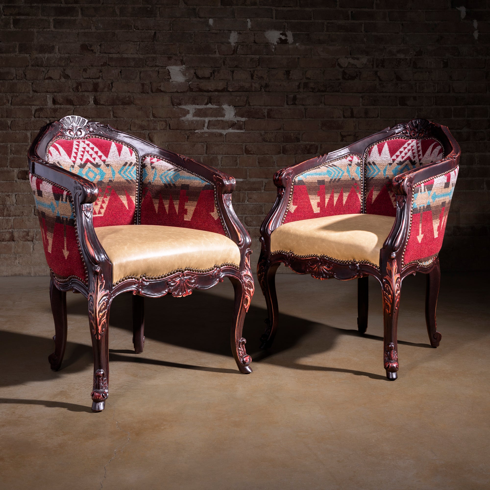 Pair of carved wood Western accent chairs with Southwest fabric and leather seats