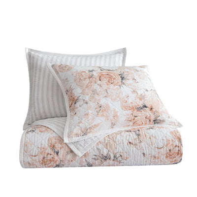 Folded Colette quilt set showing blush floral side with coordinating sham and gray ticking stripe reverse side behind.