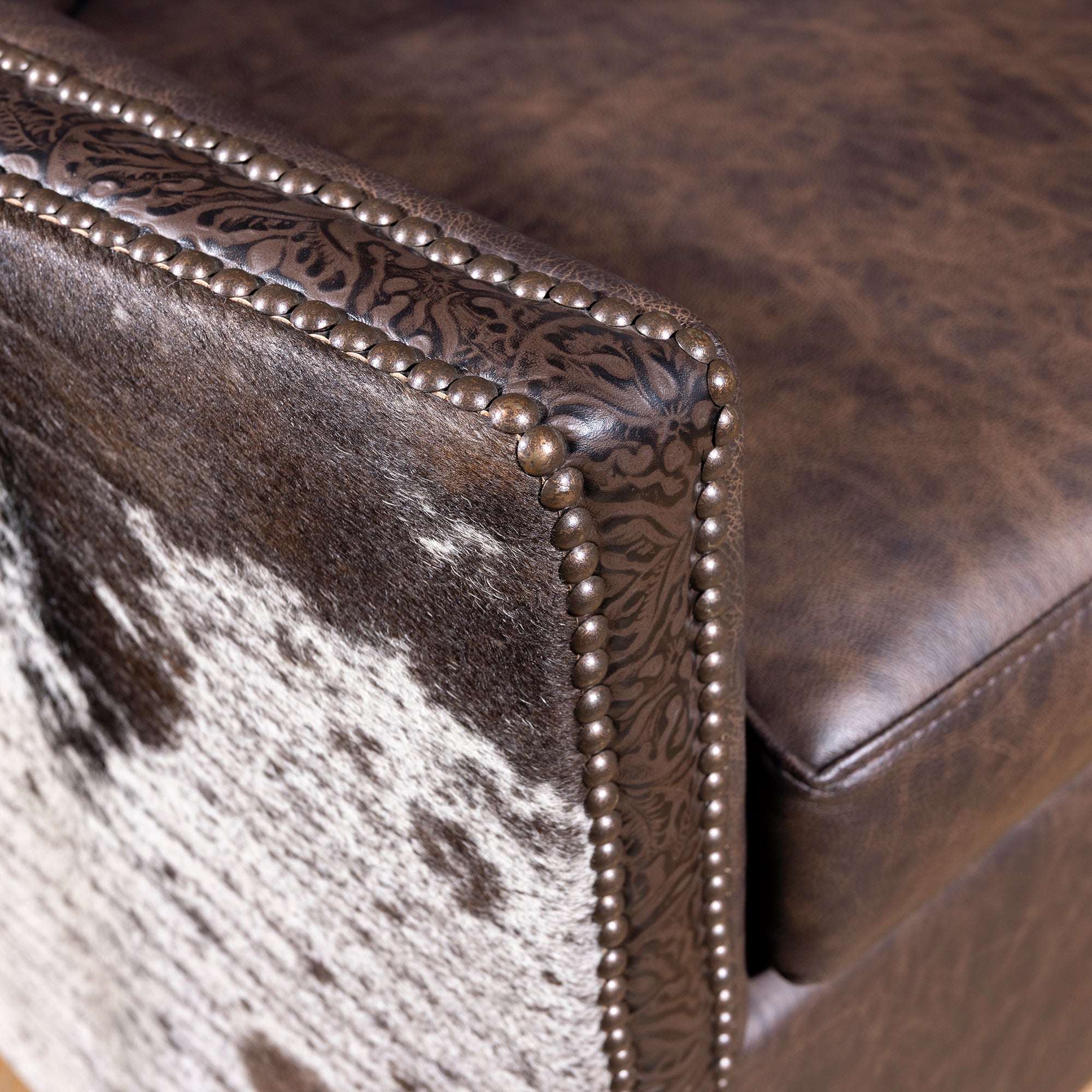 Detailed view of nailhead and hand-tooled leather trim on Conch Canyon Swivel Chair