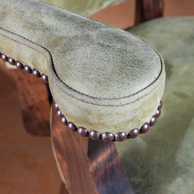 Close-up of sage-green leather arm with nailhead trim on Coronado Axis Bar Stool
