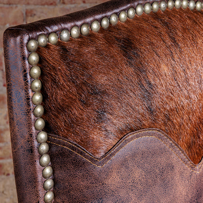 Close-up of hair-on cowhide yoke panel  and nailhead trim on Western dining chair