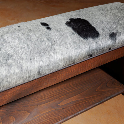 Close-up of natural gray and black cowhide cushion on bench