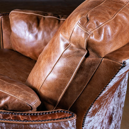 Cowhide back panel and leather detail on Western cuddler recliner