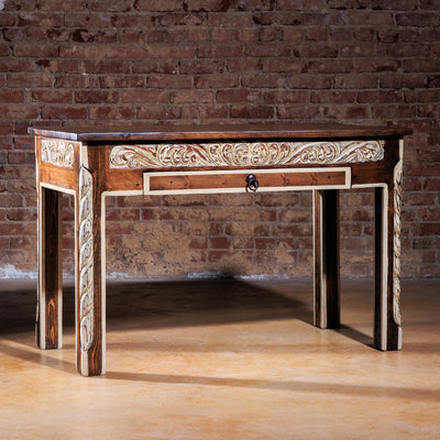 Front angle of The Durango Writing Desk showcasing carved floral apron and rustic wood finish