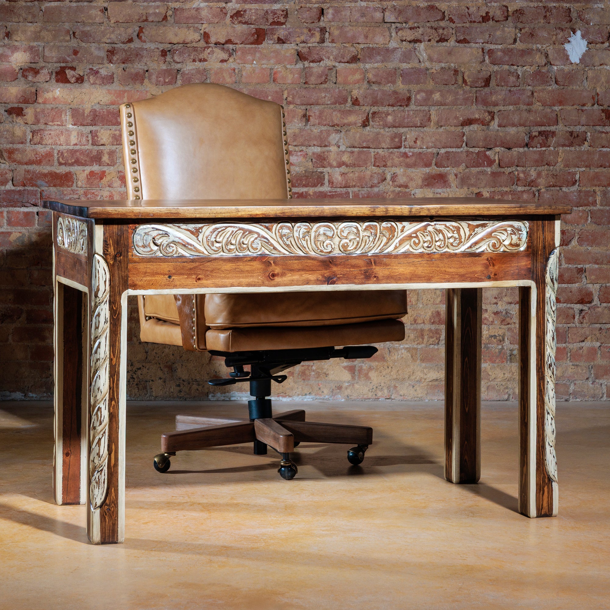 The Durango Writing Desk paired with a Western leather desk chair in a rustic office setting