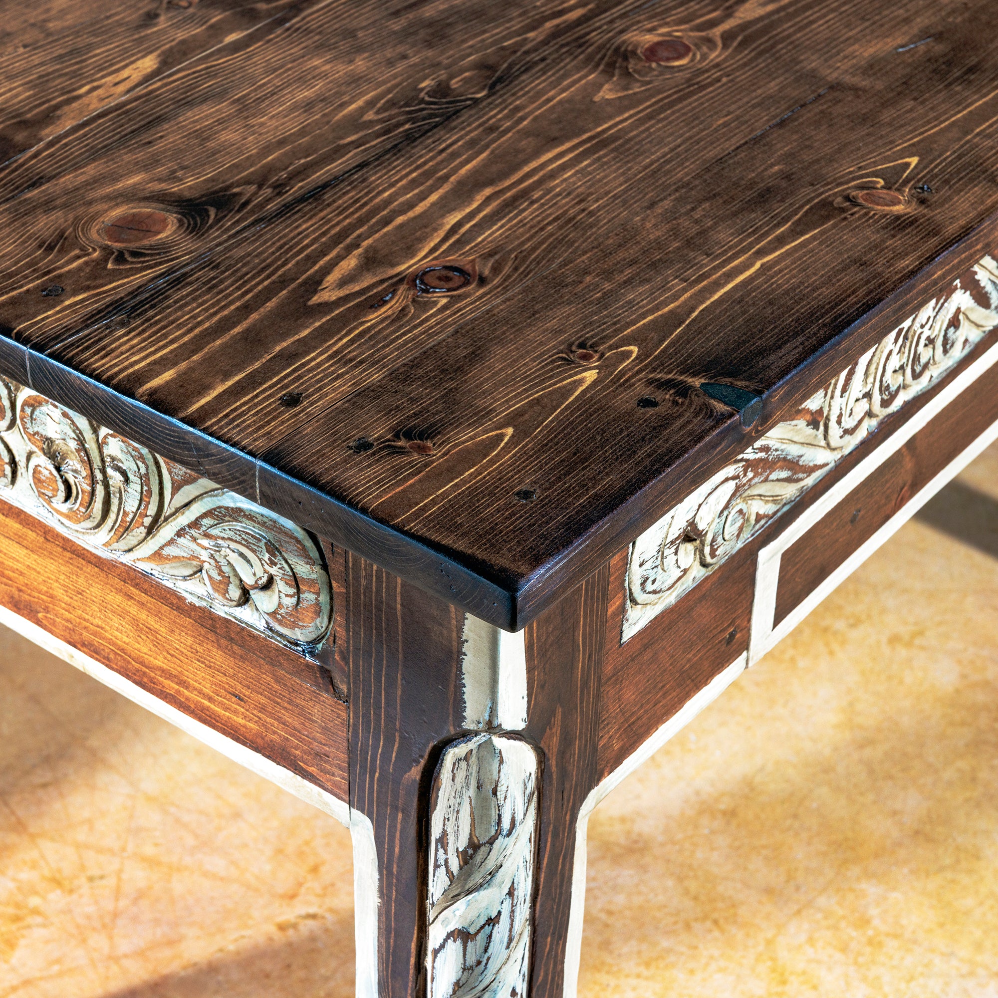 Detail of rustic solid wood top on The Durango Writing Desk showing natural knots and rich grain