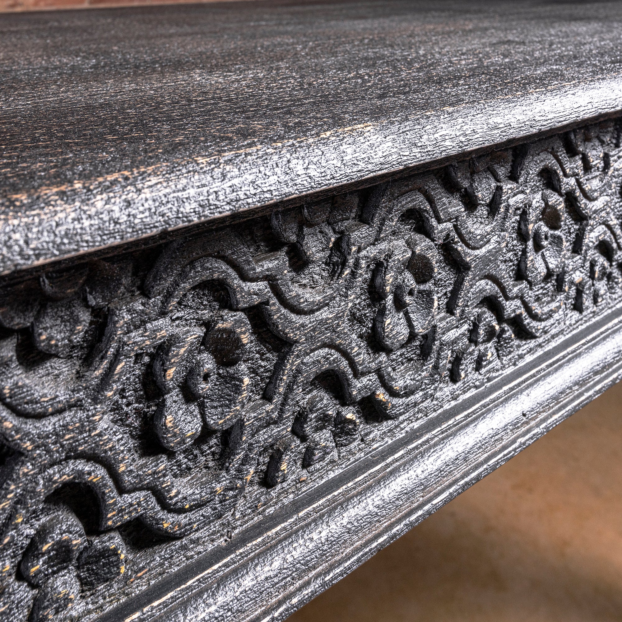 Fortville Carved Dining Table western hand carved dining table close-up showing carved apron pattern and weathered black wood finish