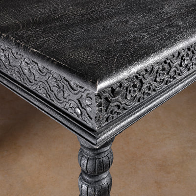 Fortville Carved Dining Table western hand carved dining table close-up with carved corner apron, black finish, and mango wood top
