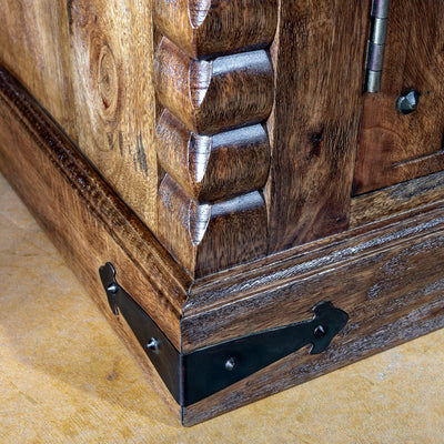 Close-up of carved base and iron strapping on the Hacienda Ironwood Buffet