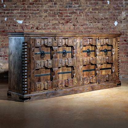 Angled view of large Western buffet with hand-carved drawers