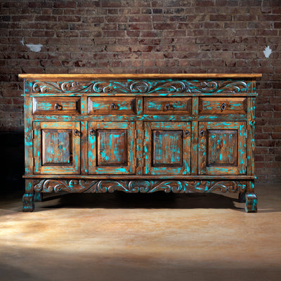 Front view of rustic turquoise hand-carved buffet with iron hardware