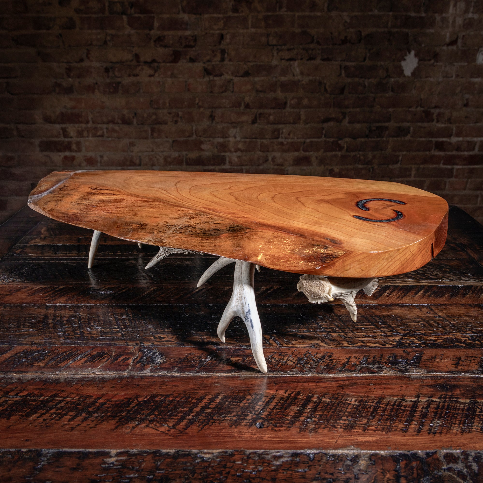 Western-style charcuterie board on antler legs — rustic entertaining gift for the hostess.