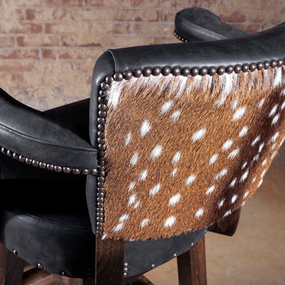 Detail of authentic axis hide upholstery framed with decorative nailhead accents.